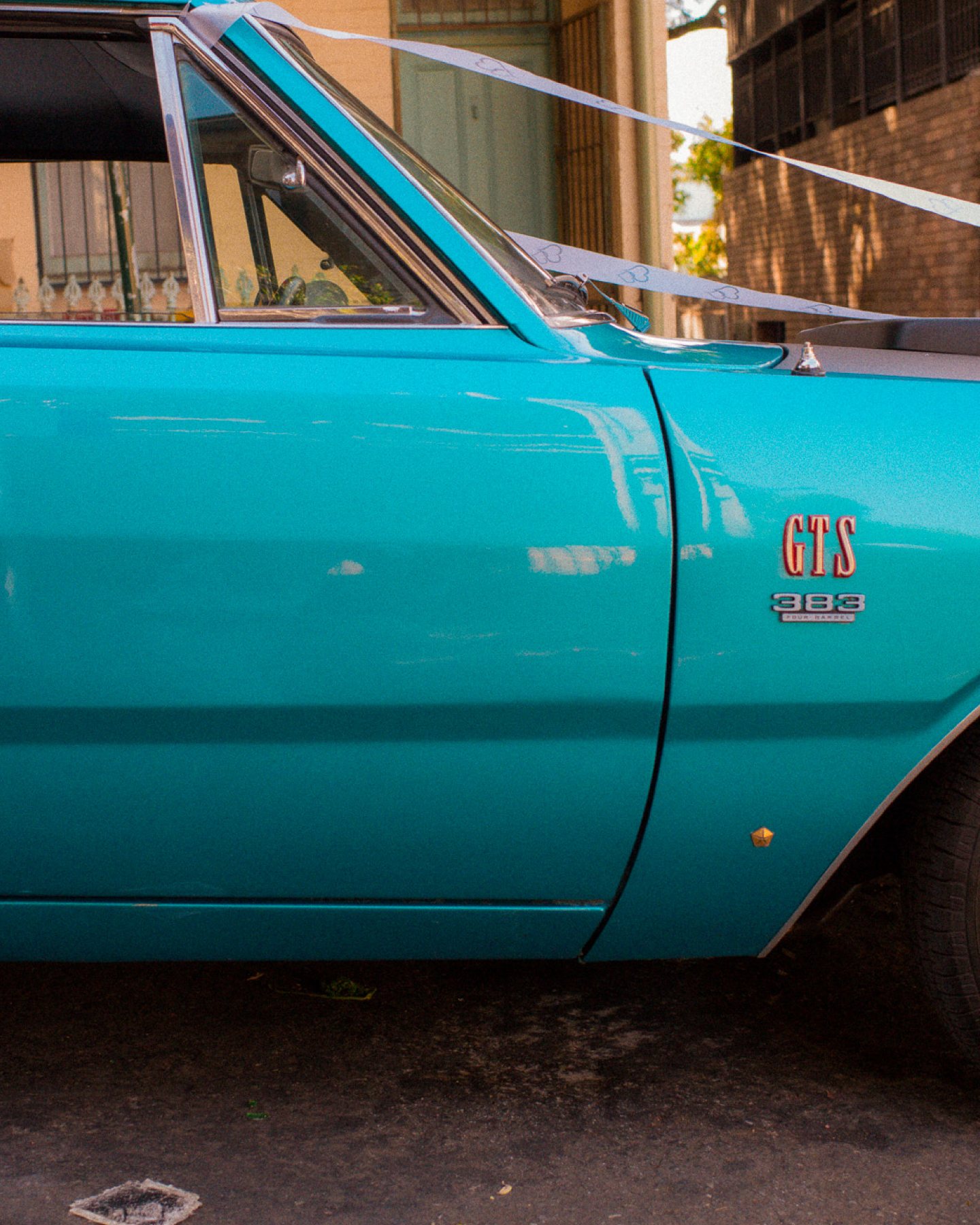 Photo of a vintage teal car door, edited with a Sombra preset