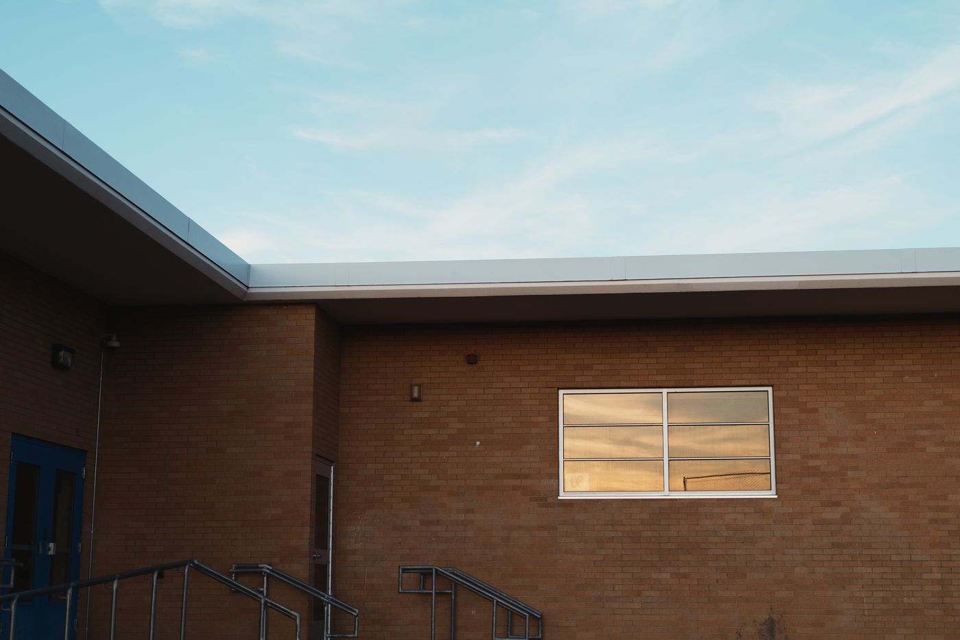 A brick building in warm light, edited with Barro