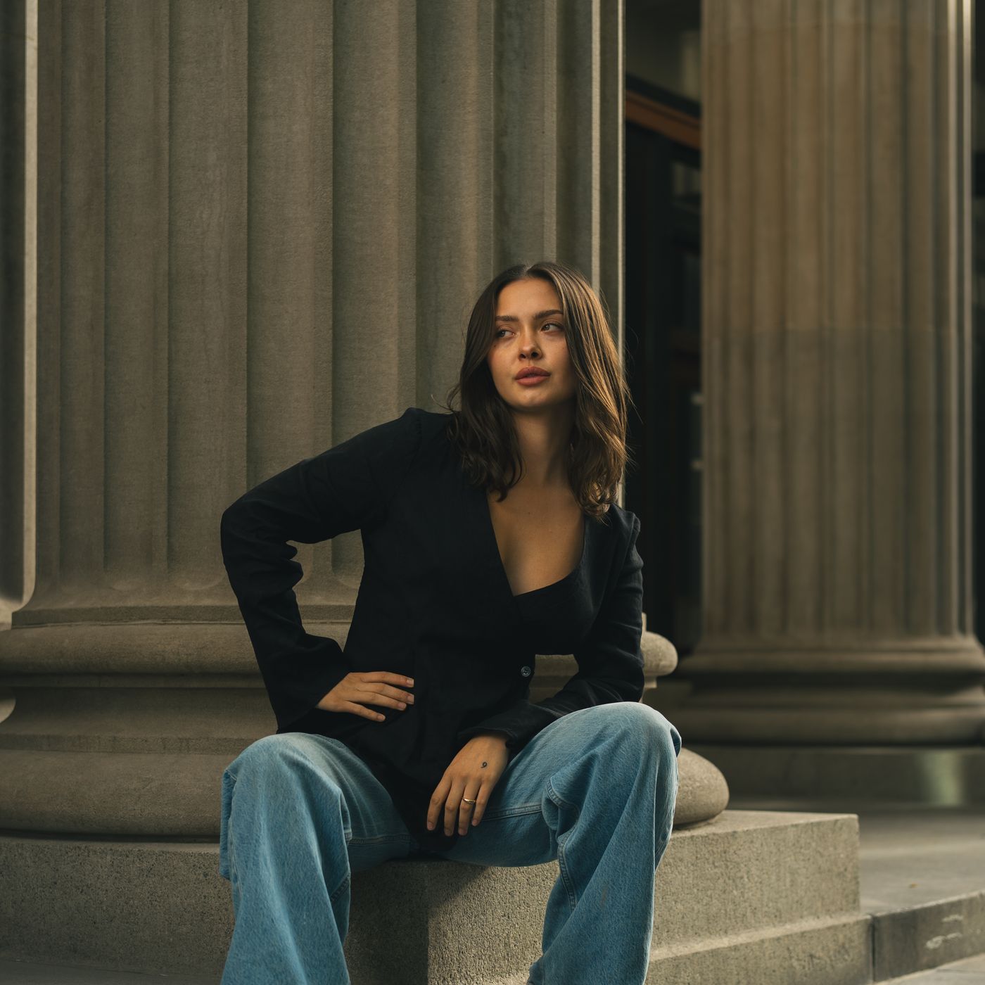 A woman sitting on stone steps, edited with Musgo