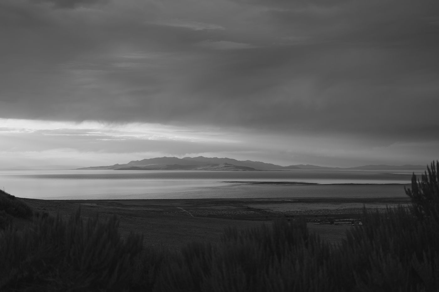 A lake at dusk in deep black and white, edited with Tinta